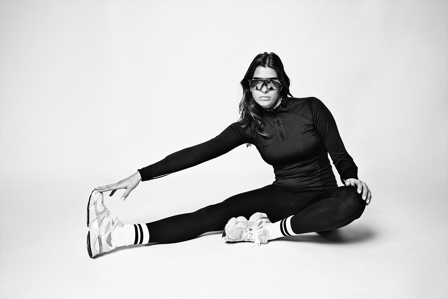 Stretching woman wearing SuperRebel Gear